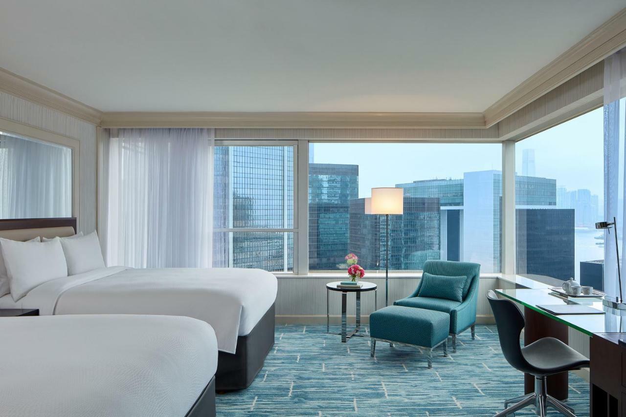 Suite Hong Kong con 2 camas dobles y acceso al salón executive